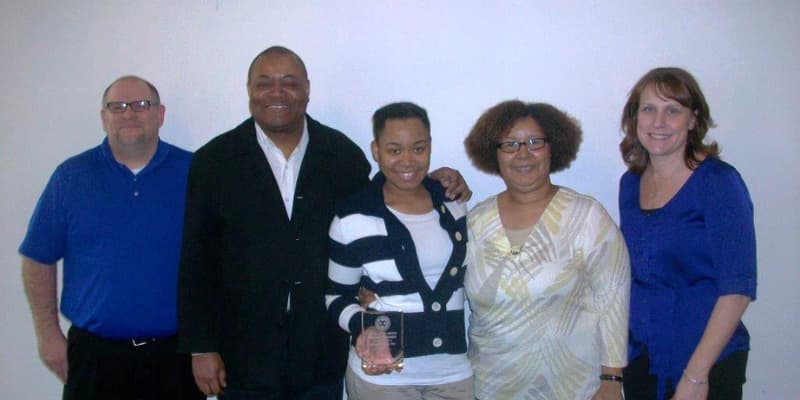 Teenager Accepting Award with family