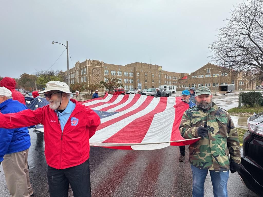 Veterans Day Parade, November 9, 2024 - QSC Members marching parade with American flag